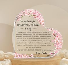 a heart shaped glass plaque with pink flowers on it and the words to my beautiful daughter in law