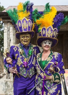 two people in colorful costumes standing next to each other