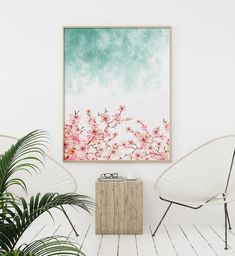 a white room with two chairs and a painting on the wall above it that has pink flowers