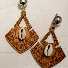 These Are Unique And Natural Handmade Design Natural Wood With Geometric Design With Hand Applied Cowrie Shells They Hang 3 Inches These Are Very Lightweight On The Ear Sturdy Silver Clip On Closure They Are One Of A Kind Afro Jewelry, Africa Craft, Africa Earrings, Handmade Boho Jewelry, Geometric Hoop Earrings, Elephant Earrings, Cowrie Shells, Hippie Earrings, Free Earrings