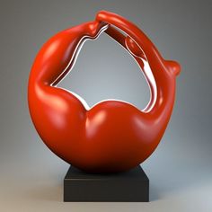 a red sculpture sitting on top of a black base