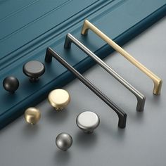 various door handles and knobs on a gray surface with the words kak above them