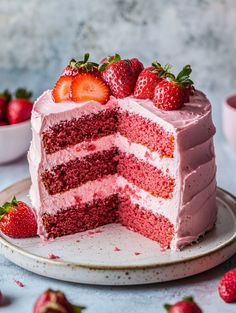 a strawberry layer cake on a plate with strawberries