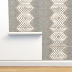 a wall with a white and beige pattern on it