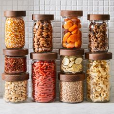 the jars are filled with different types of nuts and cereals, including cashews