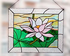 a stained glass window with a pink flower