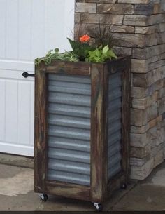 a planter made out of an old metal container is sitting in front of a door