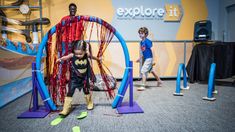 two young children playing in an exhibit