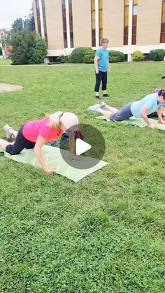 people doing yoga in the grass on their stomachs