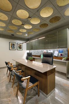 an office with several chairs and a counter in front of the counter is decorated with circular lights