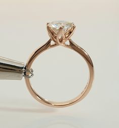 a close up of a ring with a diamond on it