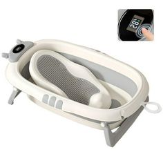 the baby bathtub is being held up by a person's hand with an electronic timer