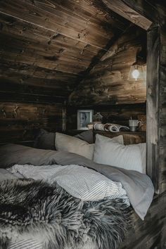 a bed in a room with wooden walls