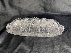 a clear glass dish sitting on top of a black cloth