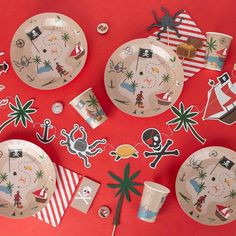 an assortment of pirate themed plates and napkins