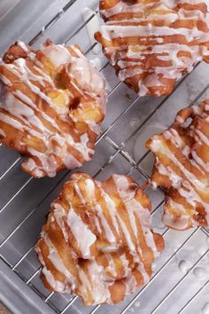 six glazed donuts sitting on top of a cooling rack