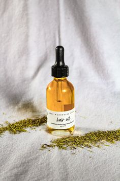 2 oz Glass Bottle | Vegan Friendly | Gluten Free | 100% Organic & Wildcrafted Ingredients The only hair oil you'll ever need! A 3 in 1 all natural plant based oil for daily use, heat protection, or scalp treatment. Handcrafted for all hair types in need of repair, moisture, thickness, length, flexibility, shine & protection. Instructions Daily | Add a small amount of oil to the palm of your hand, rub hands together & apply to hair after showering or in the morning to tame any loose hairs. Heat P Hair Oil Organic, Hair Oil Business Aesthetic, Hair Oil Photography Ideas, Hair Oil Product Photography, Hair Oil Photography, Hair Oil Packaging Design, Hair Oil Aesthetic, Hair Oil Bottle, Skincare Lifestyle