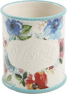 a white and blue flowered vase with the words hello written on it's side