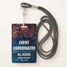 a lanyard with an event id card attached to it and fireworks in the background