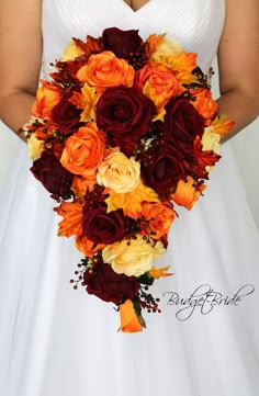 a bridal holding a bouquet of orange and red flowers on her wedding day,