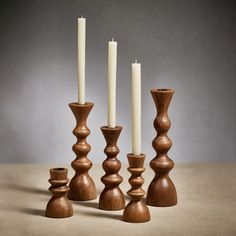 a group of wooden candlesticks sitting next to each other