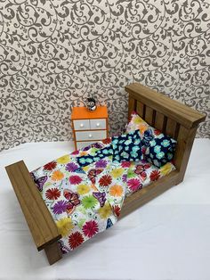 a small bed with colorful sheets and pillows