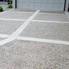 a fire hydrant sitting in the middle of a driveway next to a garage door