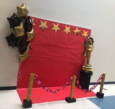 a red carpet with black and gold decorations on it, along with two golden stars