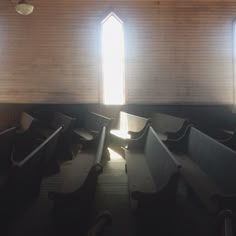 an empty church with pews and sunlight coming through the window