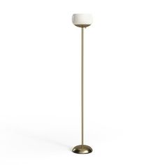 a floor lamp with a white light on it's side and a gold base