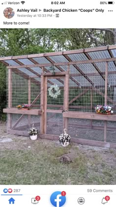 an image of a chicken coop with flowers in the front and on the back side