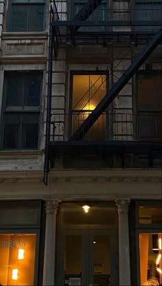 a fire hydrant sitting in front of a tall building