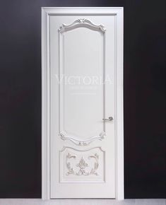 a white door with an ornate design on the front and side panels, against a black background