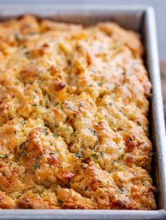 a casserole dish with cheese and herbs