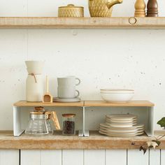 the shelves are filled with dishes and cups