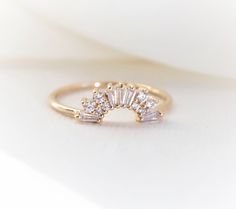 "This elegantly handmade vintage Art Deco-inspired wedding band features a glittering cluster of tapered baguettes and round stones. Before you order the band, please order a home try-on wax model here https://etsy.me/2TRvaLz There will be a 20% restocking fee deducted from your refund in case you need to return the band. So we highly recommend ordering the wax sample to see how it fits with your engagement ring. ❁❁ I T E M ∙ D E T A I L S ❁❁ ✦Stone: Conflict-Free Natural White Diamonds (SI or b Wedding Band Above Engagement Ring, Art Deco Engagement Ring And Wedding Band, Art Deco Band, Vintage Inspired Engagement Rings Art Deco Diamond, Baguette Cut Sparkling Jewelry For Wedding, Sparkling Baguette Cut Jewelry For Wedding, Art Deco Yellow Gold Wedding Rings, Art Deco Wedding Ring With Single Cut Diamonds, Round Engagement Ring With Curved Wedding Band