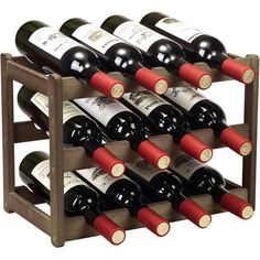 a wooden wine rack filled with lots of red and white wine bottles on top of each other