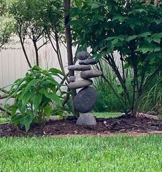 some rocks stacked on top of each other in the grass