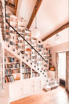 a room with bookshelves and stairs in it