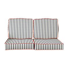 two black and white striped couches with red piping on the backrests