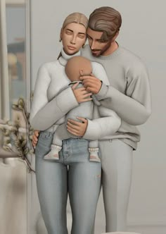 a man and woman are holding a baby in front of a mirror with flowers on it