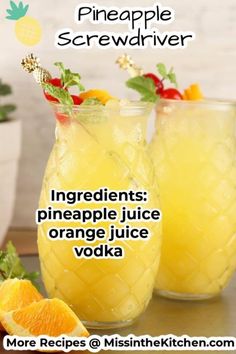 two glasses filled with orange juice and garnished with pineapple