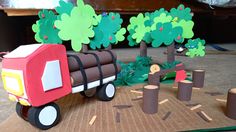 a paper model of a truck with trees on the side and cutouts in the middle