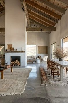 a living room filled with furniture and a fire place in the middle of an open floor plan