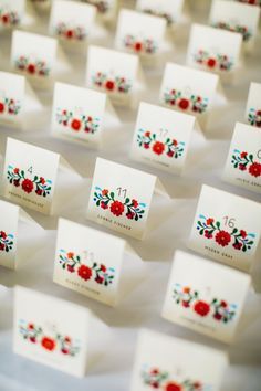 many small cards with red flowers on them