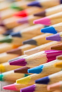 many colored pencils are lined up together