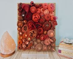 a close up of a decorative object on a table next to some books and a rock