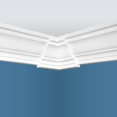 the corner of a ceiling with blue walls and white molding on it's edges