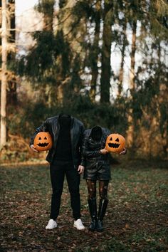 a man and woman holding pumpkins in their hands