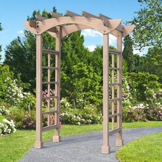 a wooden arbor in the middle of a garden